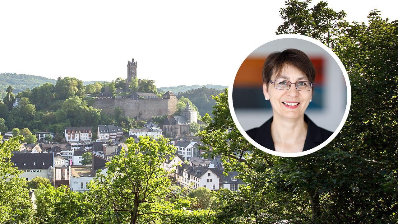 Propstei Nord-Nassau Burg im Hintergrund, ein Frauenportrait in einem Kreis daneben